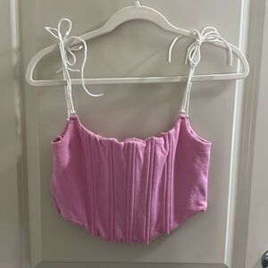 Pink top with white straps that tie